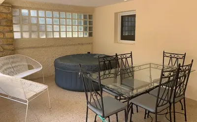 a room with a table and chairs and a barrel at Ravissant logement avec jacuzzi in Lançon-Provence