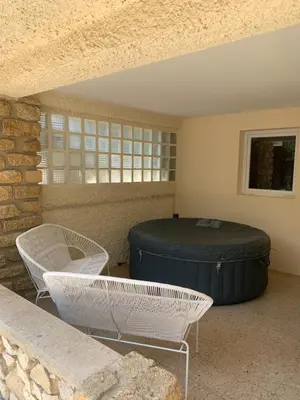 a patio with two chairs and a large barrel at Ravissant logement avec jacuzzi in Lançon-Provence