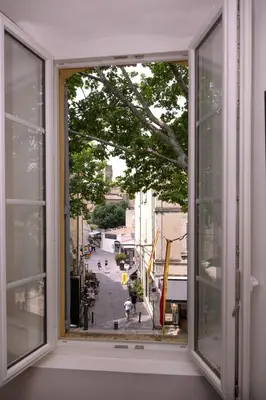 a window with a view of a city street at Le Nostradamus - Magnifique appartement cours principal plein centre avec parking in Salon-de-Provence