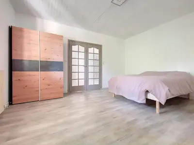 a bedroom with a bed and a large closet at Gites Partage des Eaux L'isle sur la Sorgue in LʼIsle-sur-la-Sorgue
