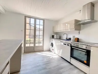 a kitchen with white appliances and a large window at Gites Partage des Eaux L'isle sur la Sorgue in LʼIsle-sur-la-Sorgue