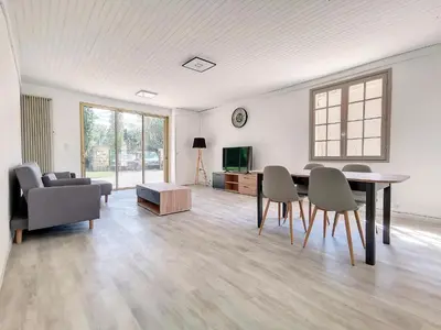 a living room with a table and chairs and a couch at Gites Partage des Eaux L'isle sur la Sorgue in LʼIsle-sur-la-Sorgue