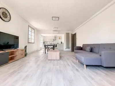 a living room with a couch and a table at Gites Partage des Eaux L'isle sur la Sorgue in LʼIsle-sur-la-Sorgue