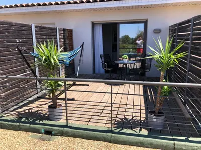 a patio with two potted plants and a table at Ma place au sud terrasse à 2 pas d’Aix in Éguilles