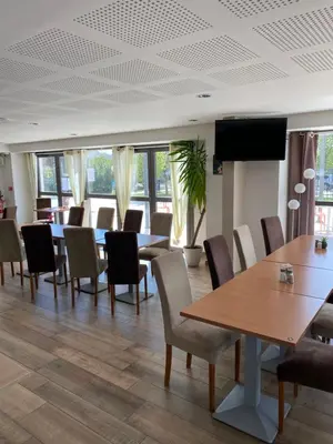 a conference room with tables and chairs and a flat screen tv at Ma place au sud terrasse à 2 pas d’Aix in Éguilles