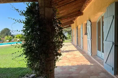 an ivy covered doorway to a house with a pool at La Villa La Source à Aix en Provence in Aix-en-Provence