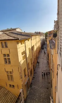 an empty street in a city with buildings at Les toits de Mignet in Aix-en-Provence