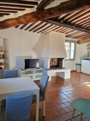 a living room with a white table and a fireplace at Les toits de Mignet in Aix-en-Provence