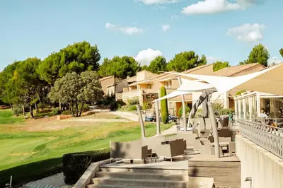 a balcony with a table and chairs and a view at ALLURA GOLF APPARTEMENT in Saumane-de-Vaucluse