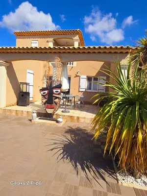 a large mask in front of a house at L'endroit incontournable in Les Baïsses