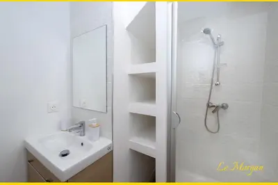 a white bathroom with a shower and a sink at Le Morgan - Magnifique appartement cours principal plein centre avec parking in Salon-de-Provence