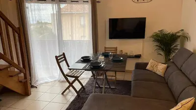 a living room with a couch and a table at Addis in Salon-de-Provence