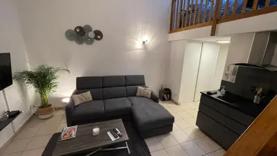 a living room with a couch and a table at Addis in Salon-de-Provence