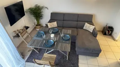 a living room with a couch and a table at Addis in Salon-de-Provence
