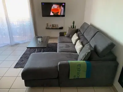 a living room with a gray couch and a table at Addis in Salon-de-Provence