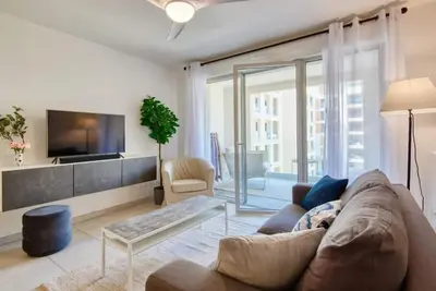 a living room with a couch and a tv at Le Fonction, meublé 4 étoiles, avec parking boxé in Aix-en-Provence