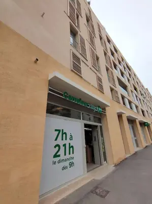 a store front of a building with a sign in the window at Le Fonction, meublé 4 étoiles, avec parking boxé in Aix-en-Provence
