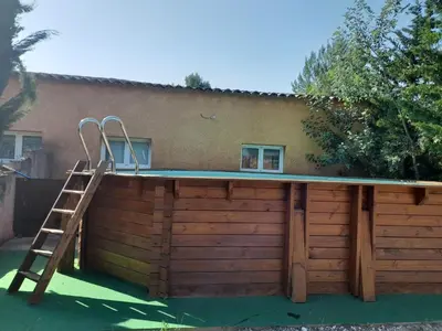 a swimming pool with a ladder next to a building at Gite à la campagne à 15 kms d'Aix in Saint-Cannat