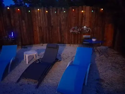 a group of blue chairs and a table and a fence at Gite à la campagne à 15 kms d'Aix in Saint-Cannat