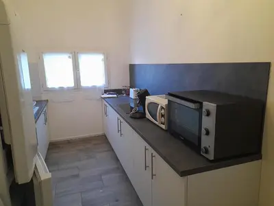 a kitchen with a counter with a microwave on it at Gite à la campagne à 15 kms d'Aix in Saint-Cannat