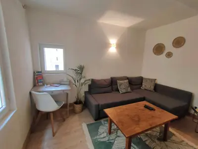 a living room with a couch and a table at Maison de ville au coeur du centre historique, parking gratuit in Apt