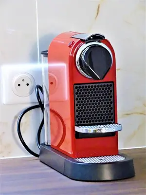 a red toaster sitting on top of a table at BLUE FOUNTAIN Luxueux Studio Aix Centre Historique -WIFI-SMART TV- in Aix-en-Provence