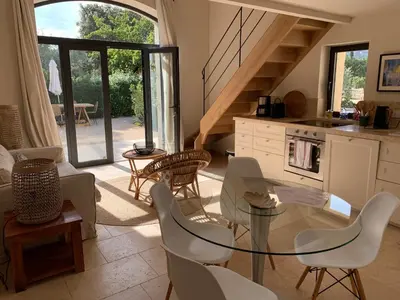 a living room with a glass table and chairs at Mas Notre Dame in Eygalières