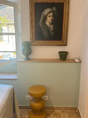 a painting of a woman sitting on a shelf in a bedroom at Mas Notre Dame in Eygalières