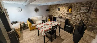 a living room with a table and a couch at Le Cabanon de Vally in Caromb