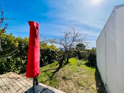 a red bag on a stand next to a building at Anse Coco Luberon - Au calme, gite en Provence avec piscine partagée et parking in Pertuis