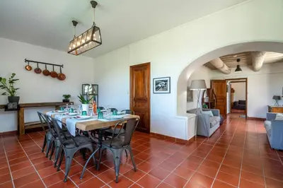 a dining room with a table and chairs at Domaine Mas Côté Cour in Maubec