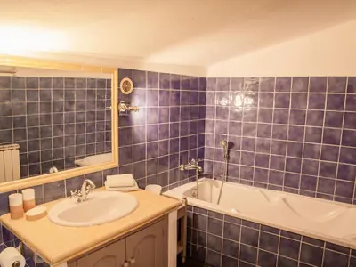 a blue tiled bathroom with a sink and a tub at Villa Martinet in Carpentras