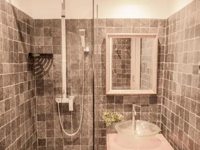 a bathroom with a shower with a sink and a mirror at Villa Martinet in Carpentras