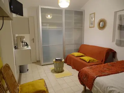 a room with a bed and a couch and a tv at Chambre indépendante in Apt