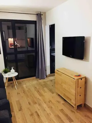a living room with a flat screen tv on a wall at Ma place au sud Aix Parking in Aix-en-Provence