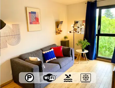 a living room with a couch and a window at Ma place au sud Aix Parking in Aix-en-Provence