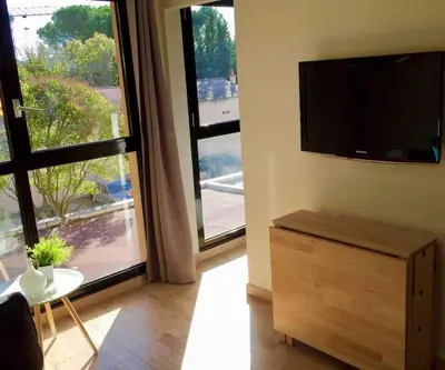 a living room with a flat screen tv on a wall at Ma place au sud Aix Parking in Aix-en-Provence