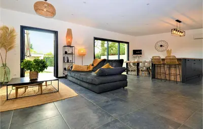 a living room with a couch and a table at 3 Bedroom Amazing Home In Montfavet in Montfavet