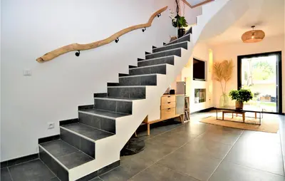 a staircase in a living room with tile floors at 3 Bedroom Amazing Home In Montfavet in Montfavet