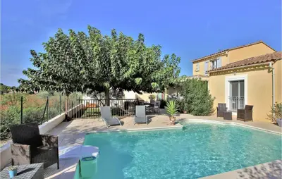 a house with glass doors and a patio at Stunning Home In Châteaurenard in Châteaurenard