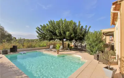 a swimming pool with chairs in a yard at Stunning Home In Châteaurenard in Châteaurenard