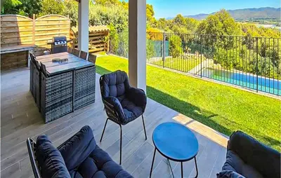 a patio with a couch and chairs and a table at Gorgeous Home In Puget in Puget