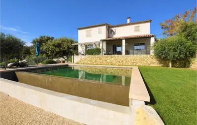 a swimming pool in front of a house at Gorgeous Home In Puget in Puget
