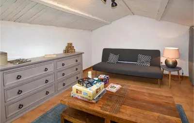 a living room with a couch and a dresser at Awesome Apartment In Rustrel in Rustrel