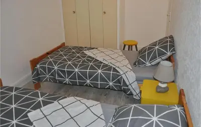 a bedroom with two beds and a table with a lamp at Awesome Apartment In Rustrel in Rustrel
