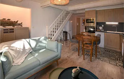 a living room with a couch and a table and a kitchen at Awesome Apartment In Rustrel in Rustrel