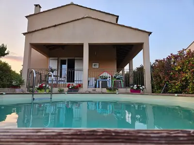 a house with a swimming pool in front of a house at AUPETIT BONHEUR in Lauris