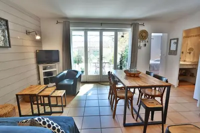 a living room with a table and chairs at Le Bastidon de Guillemette in Gordes