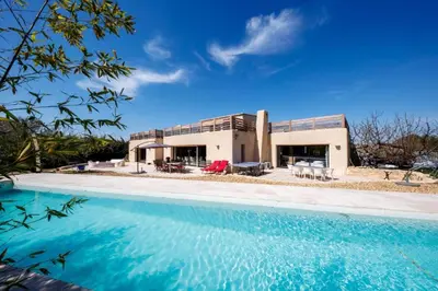a house with a swimming pool in front of it at Sérénité en Provence, Climatisée in La Roque-sur-Pernes