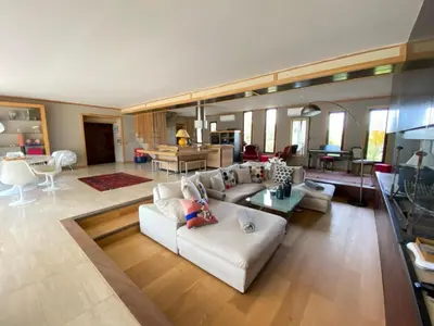 a living room with a white couch and a table at Sérénité en Provence, Climatisée in La Roque-sur-Pernes